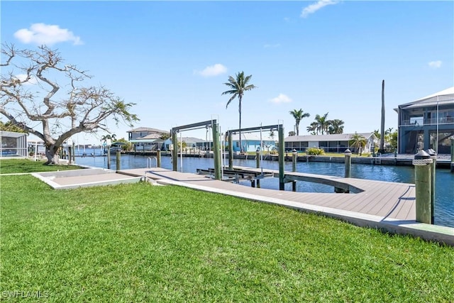 dock area featuring boat lift, a yard, and a water view