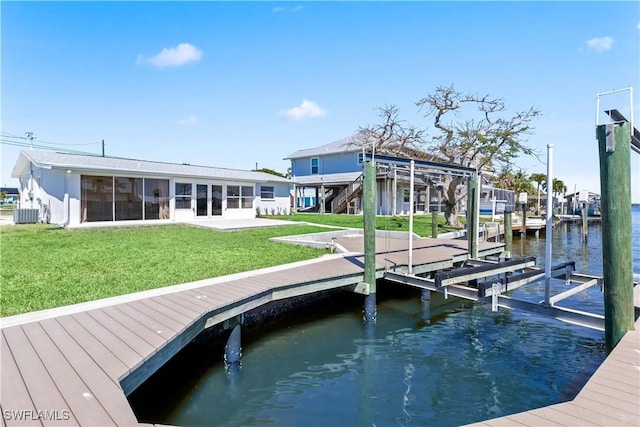 view of dock featuring central AC unit, a lawn, a water view, and boat lift