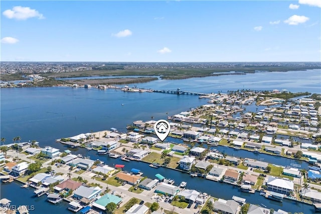 drone / aerial view with a residential view and a water view