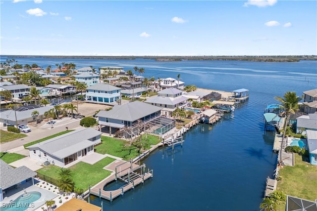 birds eye view of property with a water view and a residential view