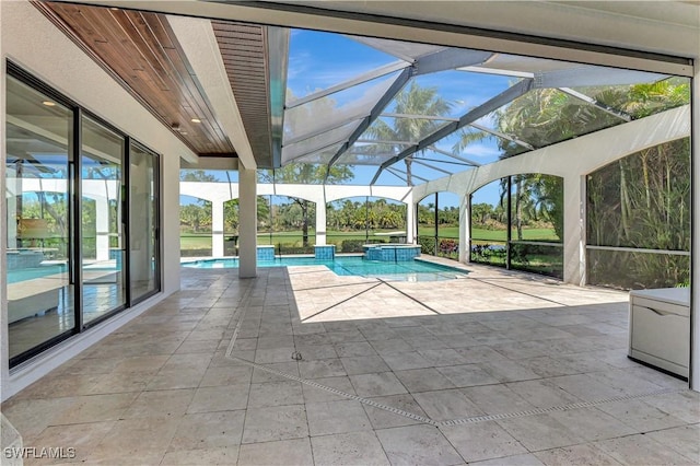 view of swimming pool with a pool with connected hot tub, glass enclosure, and a patio