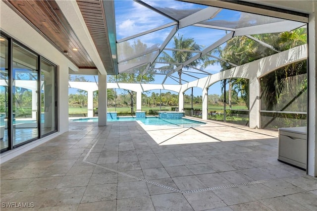 view of pool with a pool with connected hot tub, glass enclosure, and a patio