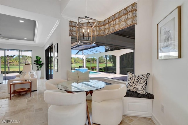 dining space with stone tile floors, recessed lighting, a sunroom, a raised ceiling, and crown molding