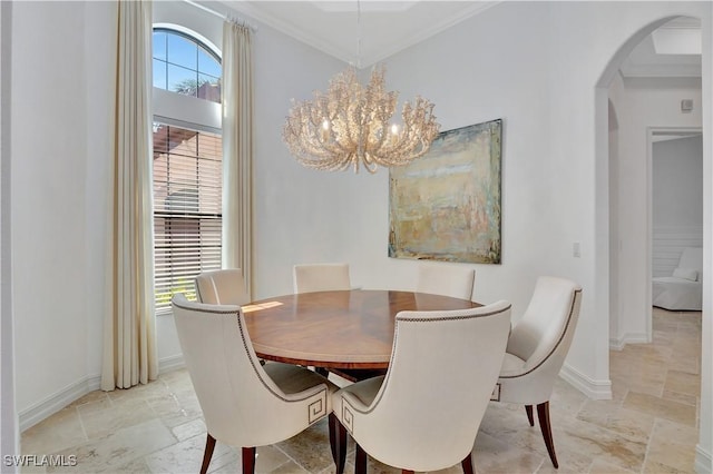 dining room with a healthy amount of sunlight, stone tile floors, arched walkways, and baseboards