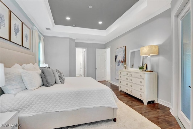 bedroom featuring dark wood-style floors, recessed lighting, a raised ceiling, visible vents, and ornamental molding