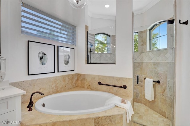 full bath with vanity, ornamental molding, a shower stall, and a bath