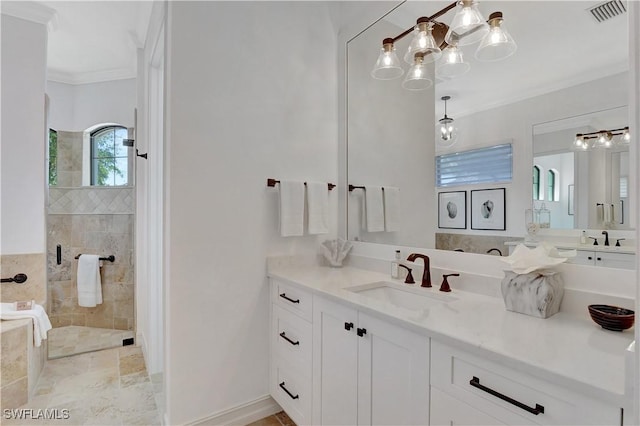 bathroom with vanity, ornamental molding, a tile shower, and visible vents