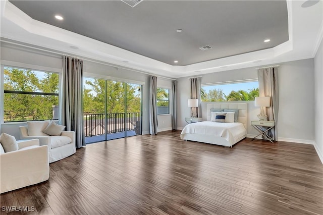 bedroom featuring wood finished floors, visible vents, baseboards, access to exterior, and a raised ceiling