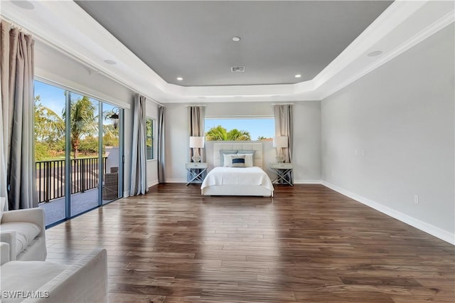 unfurnished bedroom featuring access to outside, visible vents, a raised ceiling, and dark wood finished floors