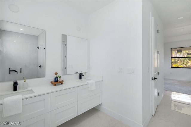 full bath featuring marble finish floor, a stall shower, a sink, double vanity, and baseboards