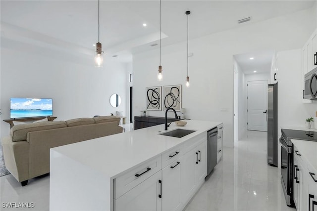 kitchen featuring visible vents, recessed lighting, appliances with stainless steel finishes, white cabinetry, and a sink