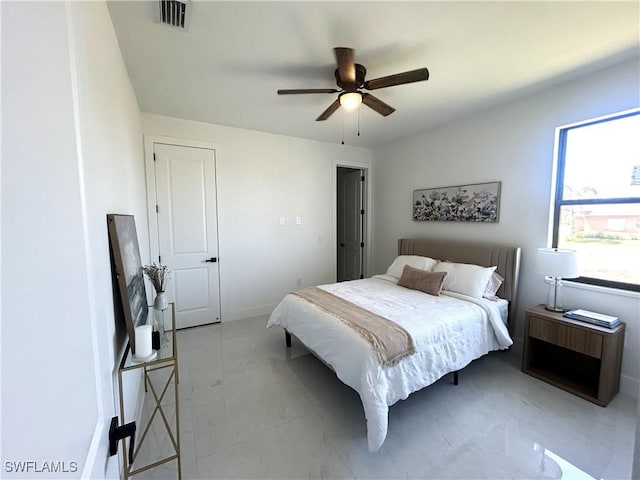 bedroom featuring a ceiling fan, visible vents, and baseboards