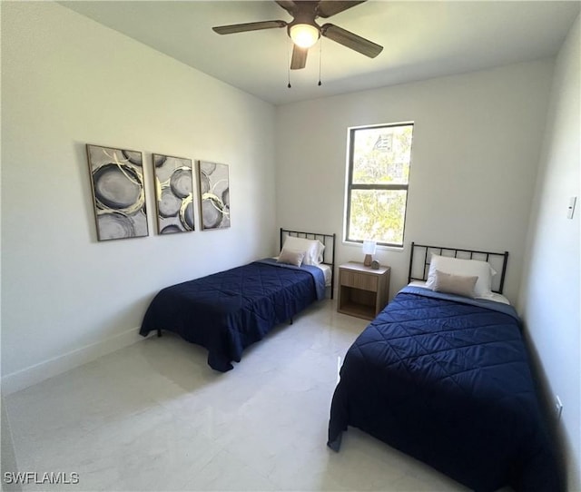 bedroom featuring baseboards and ceiling fan