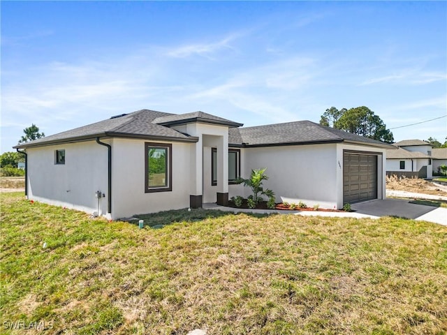 view of front of property featuring a front lawn, driveway, an attached garage, and stucco siding