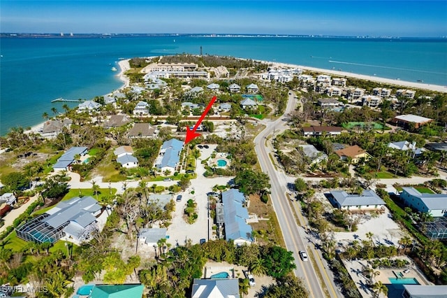 birds eye view of property with a water view and a residential view