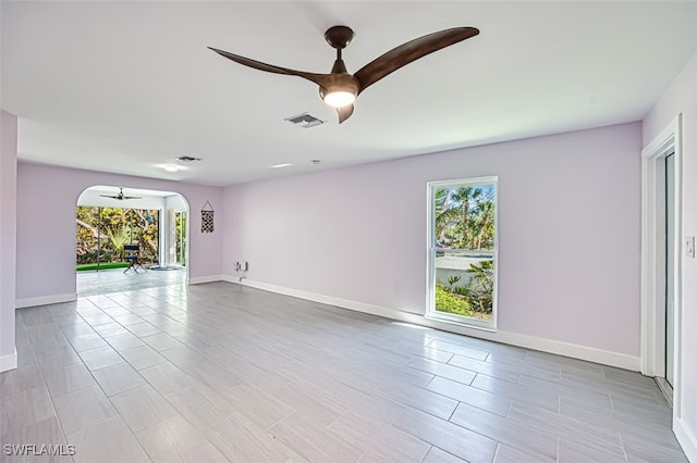 unfurnished room with visible vents, baseboards, and a ceiling fan