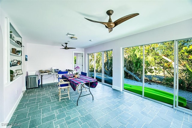 sunroom / solarium featuring visible vents and ceiling fan