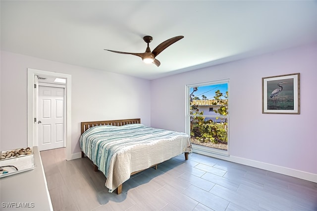 bedroom featuring baseboards and ceiling fan