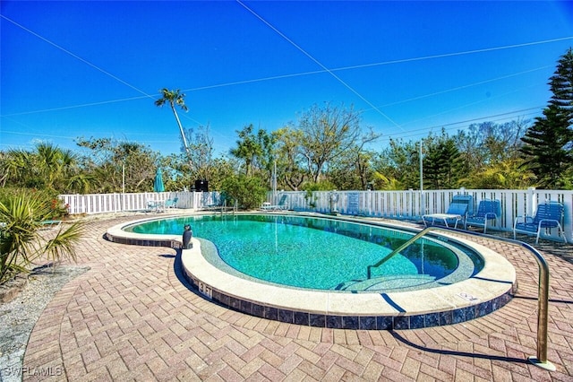 community pool featuring a patio and a fenced backyard