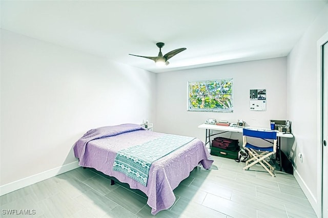 bedroom featuring a ceiling fan and baseboards