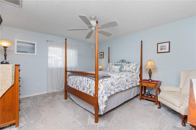 carpeted bedroom with ceiling fan, visible vents, and baseboards