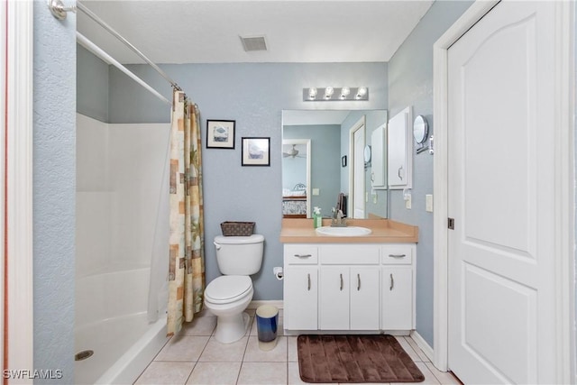 bathroom with toilet, a shower with shower curtain, tile patterned flooring, and visible vents