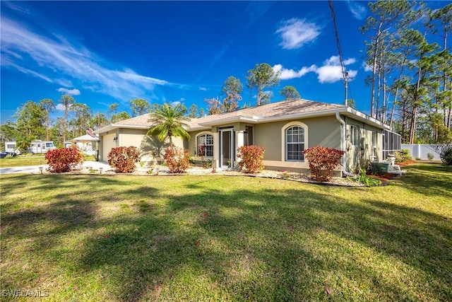 ranch-style house featuring a garage, fence, a front lawn, and stucco siding