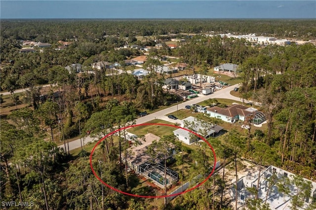 aerial view featuring a wooded view