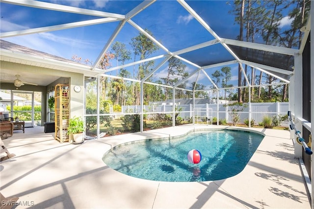 view of pool with glass enclosure, a patio area, fence, and a fenced in pool