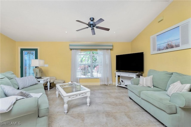 living area with lofted ceiling, a ceiling fan, and baseboards