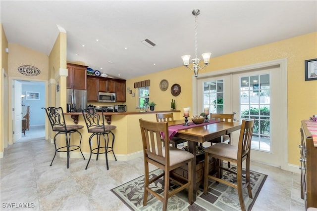 dining room featuring lofted ceiling, a chandelier, visible vents, baseboards, and french doors