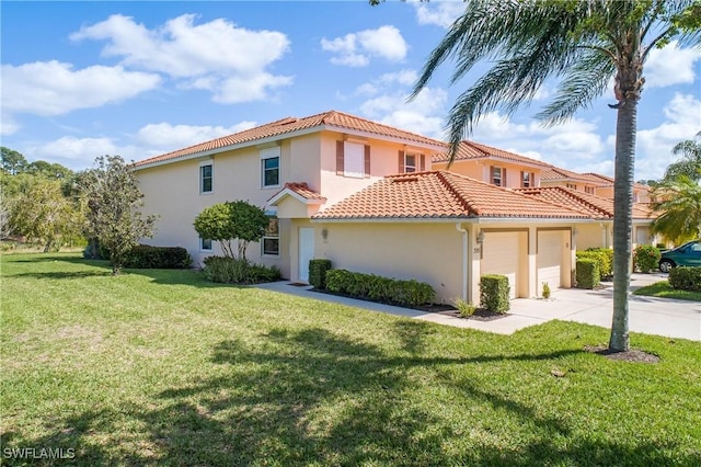 mediterranean / spanish house with an attached garage, stucco siding, a front lawn, concrete driveway, and a tiled roof