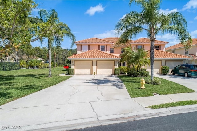 mediterranean / spanish home featuring stucco siding, driveway, a front yard, and a garage