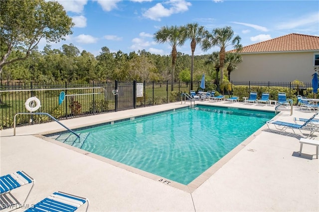 pool featuring a patio and fence