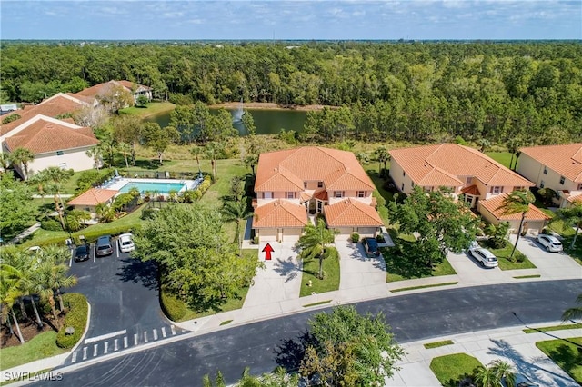 bird's eye view with a wooded view and a water view