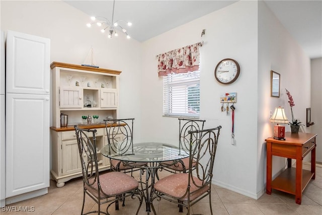 dining room with light tile patterned floors, baseboards, and an inviting chandelier