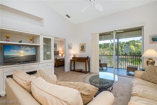 living room featuring visible vents, light carpet, and a ceiling fan