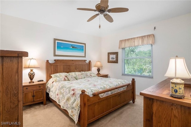 bedroom with light colored carpet and a ceiling fan