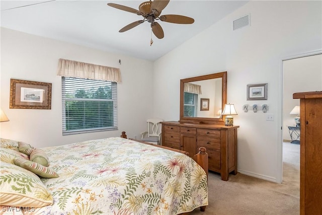 bedroom with baseboards, visible vents, ceiling fan, vaulted ceiling, and light carpet