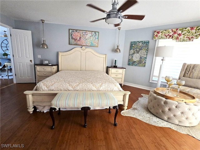 bedroom featuring dark wood finished floors, a ceiling fan, and baseboards