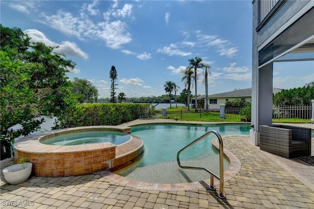 view of swimming pool with a pool with connected hot tub, fence, and a patio