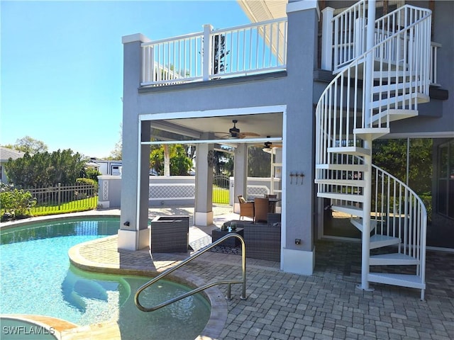 exterior space with a fenced in pool, ceiling fan, stairway, fence, and a patio area