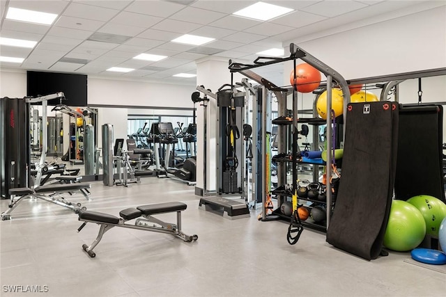 gym with a paneled ceiling