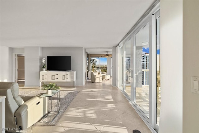 living room featuring ceiling fan and light tile patterned flooring