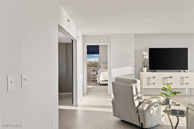 living area with light tile patterned floors and baseboards