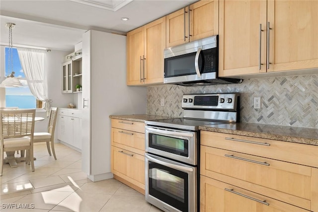 kitchen with light brown cabinets, light tile patterned flooring, appliances with stainless steel finishes, pendant lighting, and tasteful backsplash