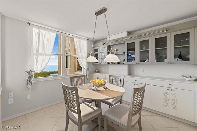 dining space with light tile patterned floors and baseboards