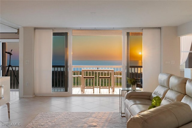 living area with tile patterned floors, expansive windows, and plenty of natural light