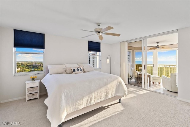 carpeted bedroom featuring ceiling fan, baseboards, and access to exterior