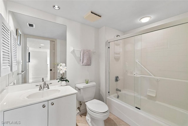 bathroom featuring visible vents, bath / shower combo with glass door, toilet, tile patterned floors, and vanity